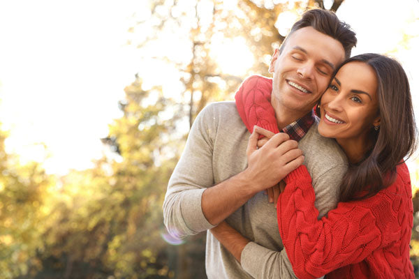 Un couple heureux se prenant dans les bras.