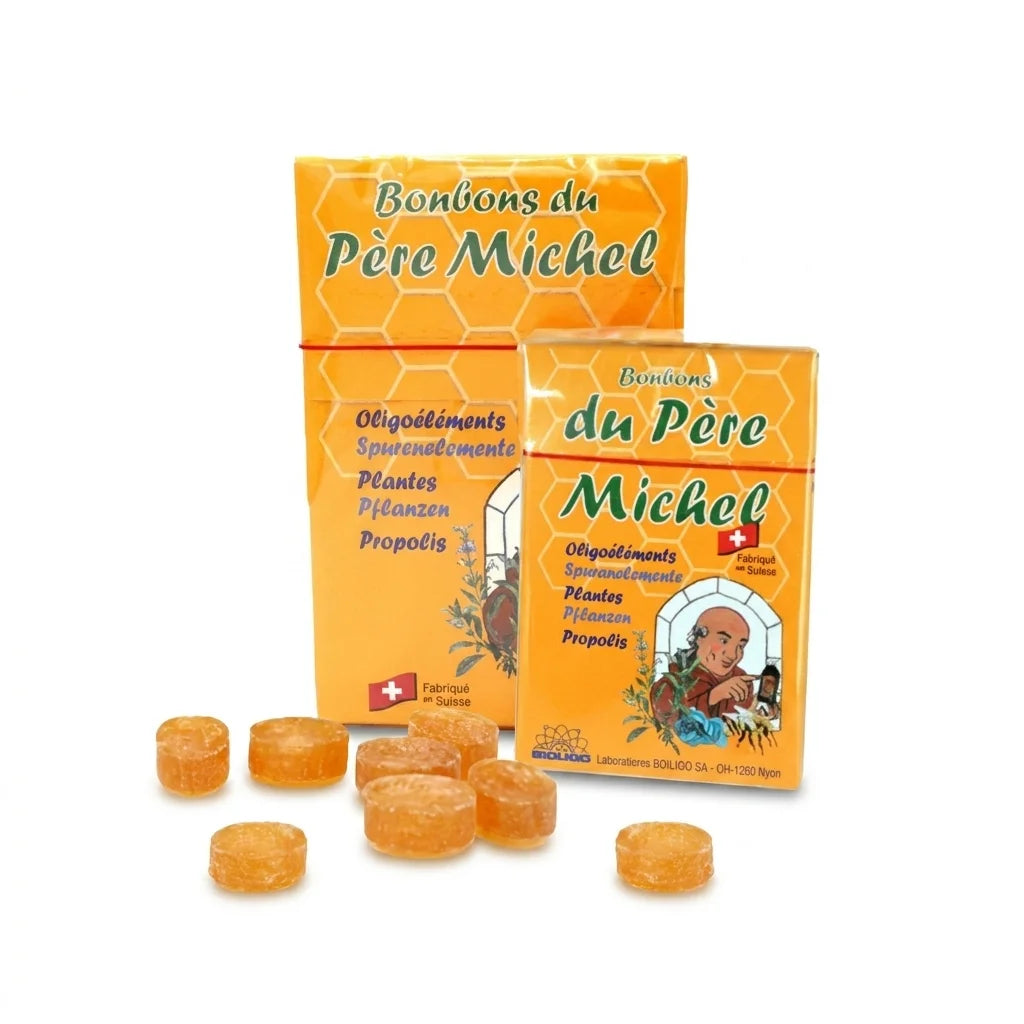 Bonbons du Père Michel Bioligo boîtes et bonbons sur fond blanc, emballage traditionnel orange et vert