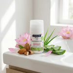 Déodorant roll-on bio Coslys blanc avec fleur de lotus rose, entouré d'aloe vera et amandes sur vanity spa