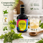 Élixir Bio Menthe Pissenlit Ortie - Bouteille avec ingrédients naturels et verre sur marbre