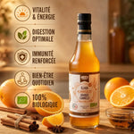 Élixir Orange-Cannelle bio : bouteille avec bénéfices santé, oranges et bâtons de cannelle sur bois