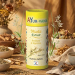 Gélules Extrait Musta Vegan Ayurvana avec herbes botaniques et packaging jaune crème sur fond naturel wellness
