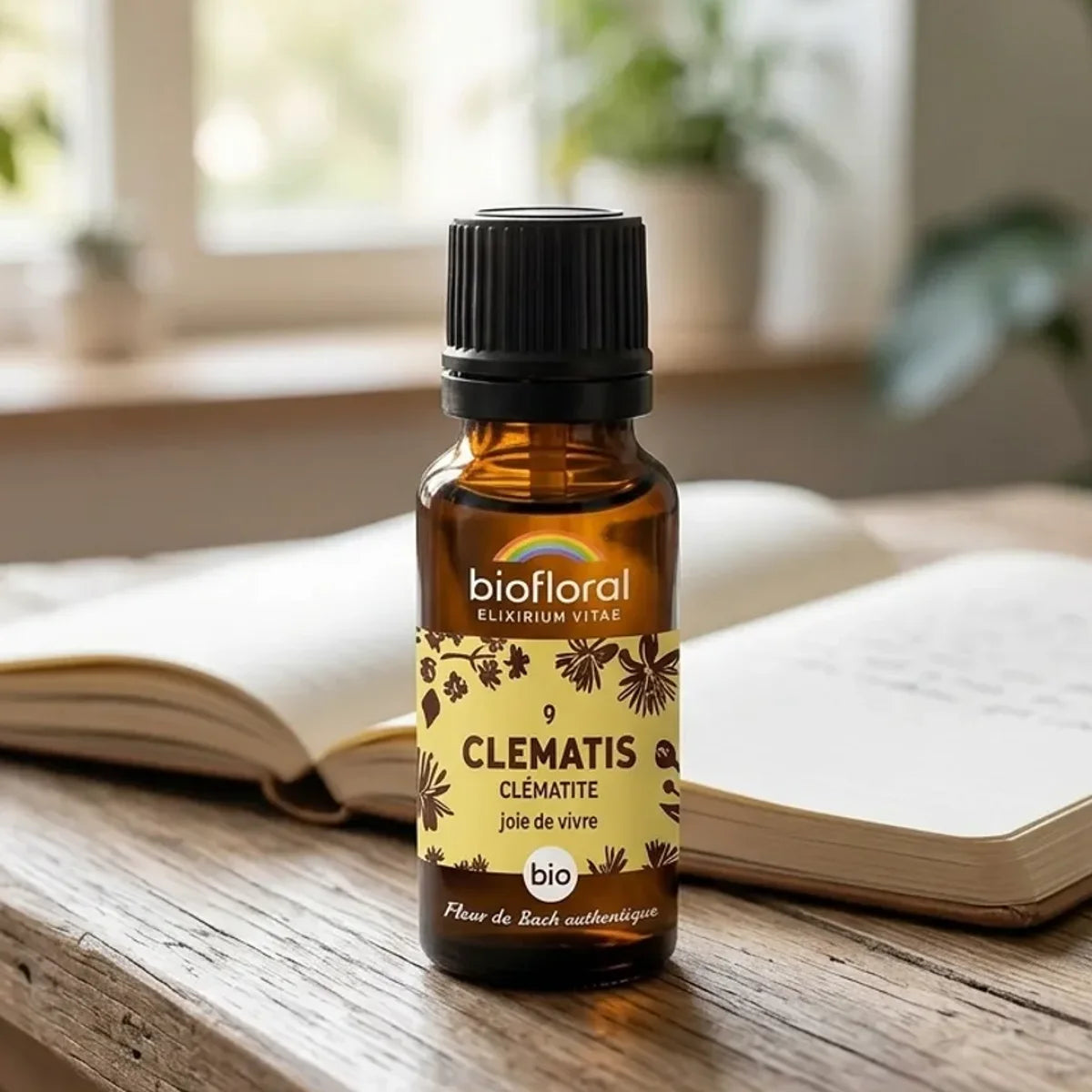 Fleur de Bach Clematis bio en granules Biofloral sur bureau avec journal et plantes