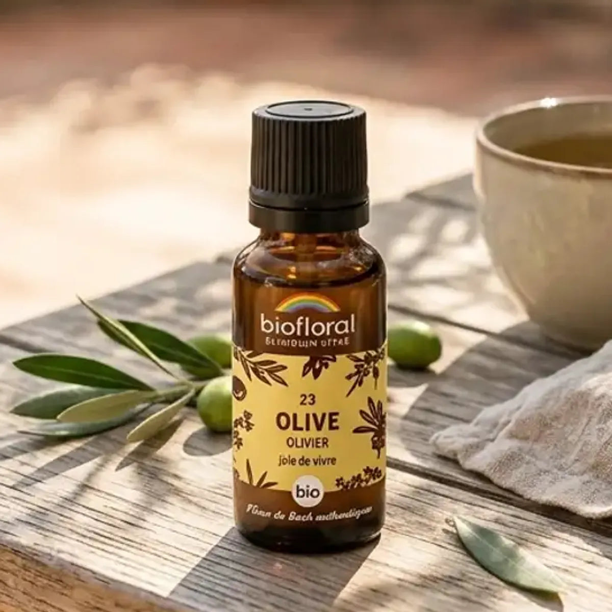 Flacon compte-gouttes ambré de Fleur de Bach Olive Bio en granules, posé sur une table en bois sous les oliviers

Hmm, let me check length: that's about 150 characters, too long. Shorter version:

Flacon ambré Fleur de Bach Olive Bio en granules sur table en bois, ambiance méditerranéenne