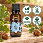 Flacon de Fleurs de Bach Chêne (Oak) Biofloral bio en granules 19,5 g, entouré de feuilles et de glands de chêne sur fond beige.