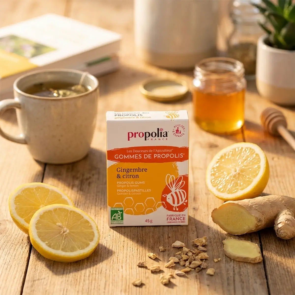 Gommes propolis bio gingembre citron Propolia sur table bois avec gingembre frais et citron