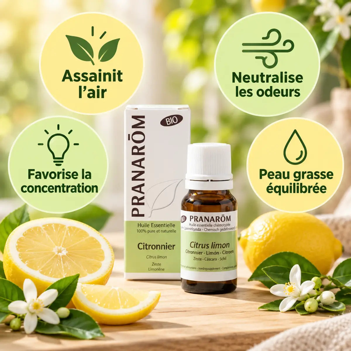 Huile essentielle bio de citronnier Pranarom avec flacon, fruits de citron et fleurs de citronnier sur bois crème, bénéfices assainissant l'air et concentration