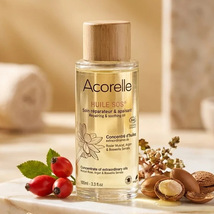 Huile SOS bio Acorelle avec flacon et ingrédients naturels sur marbre