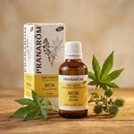 Huile végétale bio de ricin Pranarom 50ml sur surface bois avec feuilles fraîches