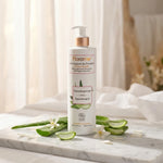 Lait corporel Florame Provence bio hypoallergénique sur marbre avec fleurs d'oranger et feuilles d'aloe vera