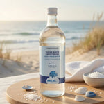 Bouteille Plasma Marin Hypertonique 1L Quinton sur ambiance wellness côtière avec éléments marins