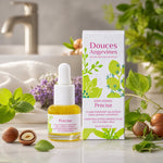 Précise Soin jour bio Douces Angevines sur meuble salle bain avec feuilles menthe et noisettes