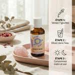 Elixir Quartz Rose avec dosage 7 gouttes, cristaux rose et instructions d'utilisation sur marbre