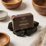 Savon d'Alep Najel au charbon bio sur morceaux de charbon, packaging marron doré