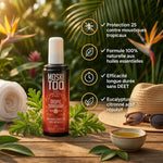 Spray Moskitoo anti-moustiques naturel aux huiles essentielles sur surface bois avec herbes tropicales
