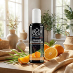 Spray d'ambiance Orange Palmarosa Aromaspray avec agrumes et feuillage dans un intérieur cosy