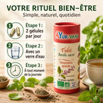 Tulsi bio Ayur-Vana en gélules avec guide posologie et feuilles basilic frais sur table bois