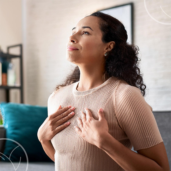 Photo d'une femme en train de prendre une respiration dans son salon