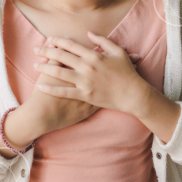 Photo d'une femme avec un t-shirt posant ses mains sur son coeur