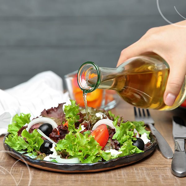 Photo d'une salade où l'on verse du vinaigre de cidre